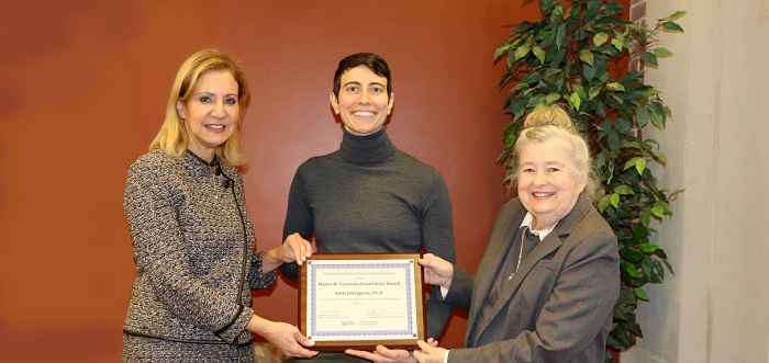 Bahira Trask and Barbara Settles present award to a graduate student