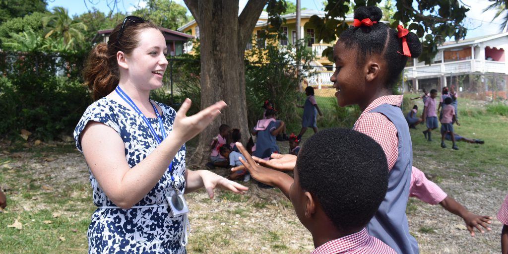 UD student speaking with children in Barbados