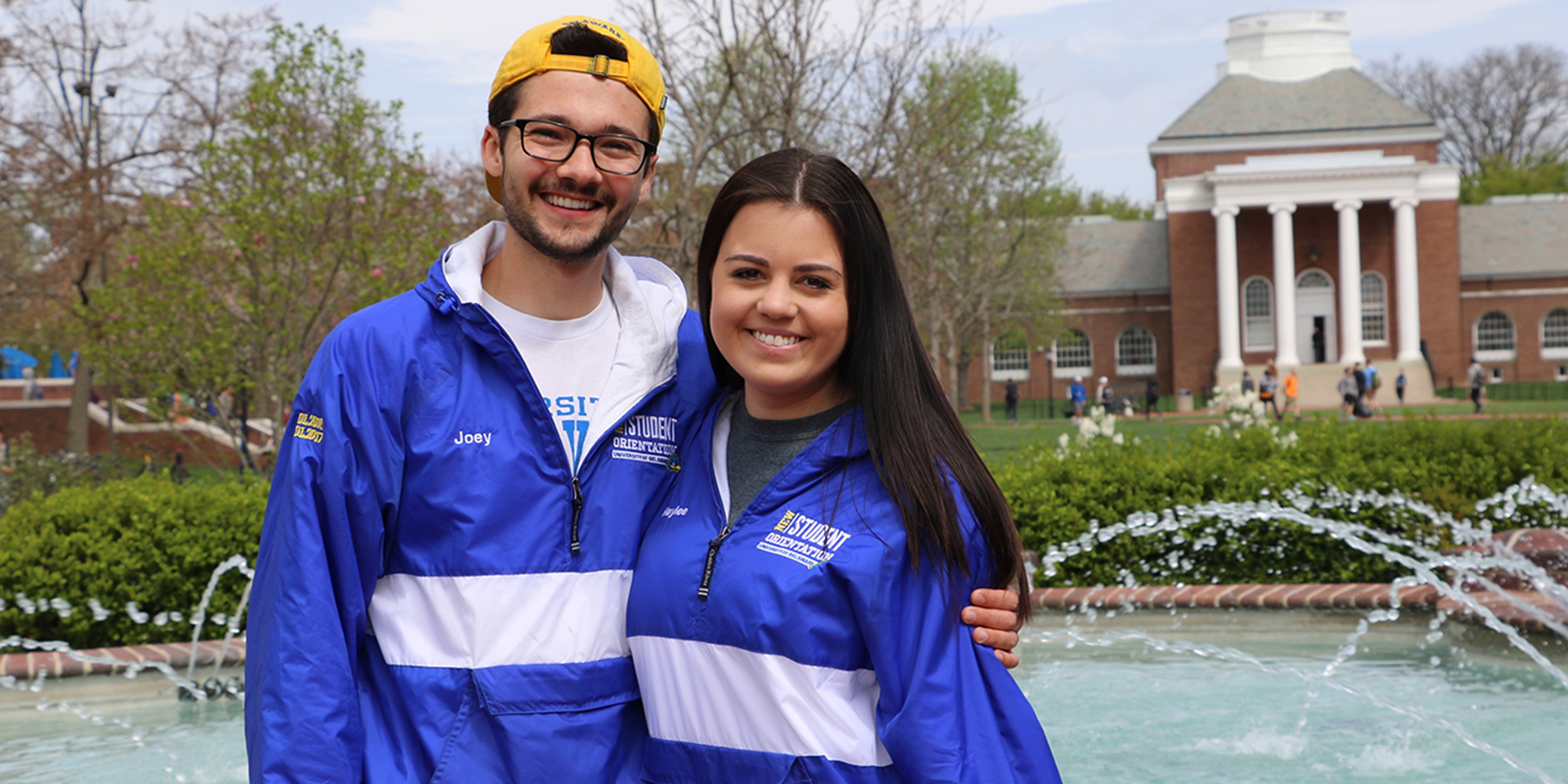 Two University of Delaware students smiling at Memorial Hall