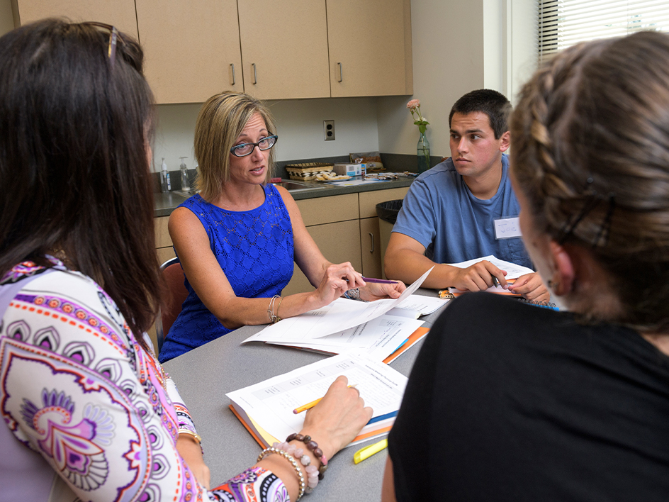 Faculty member in a meeting with three students