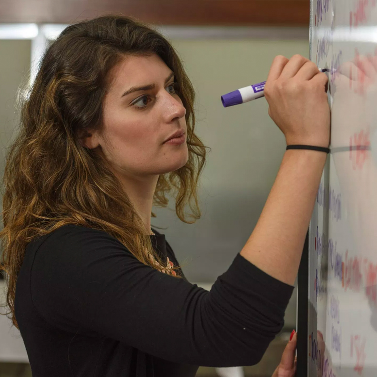 Student writes on whiteboard