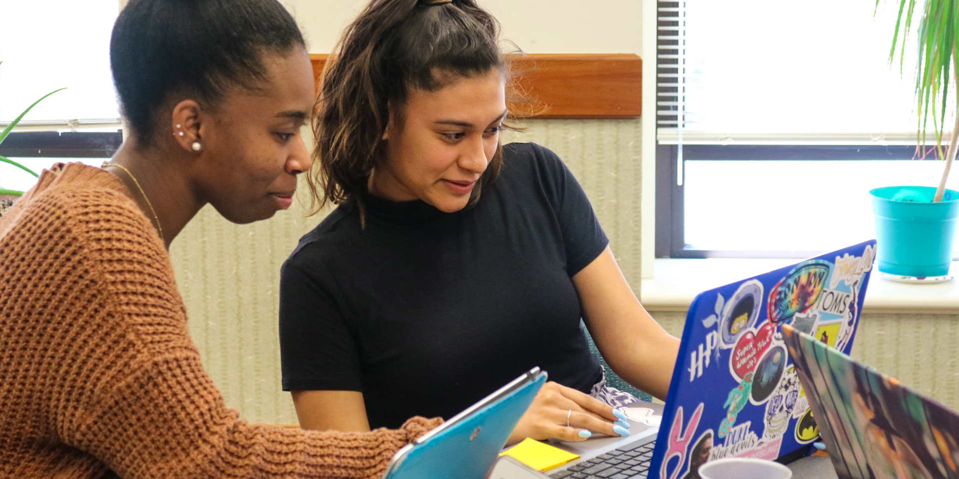 Two students working on their laptops