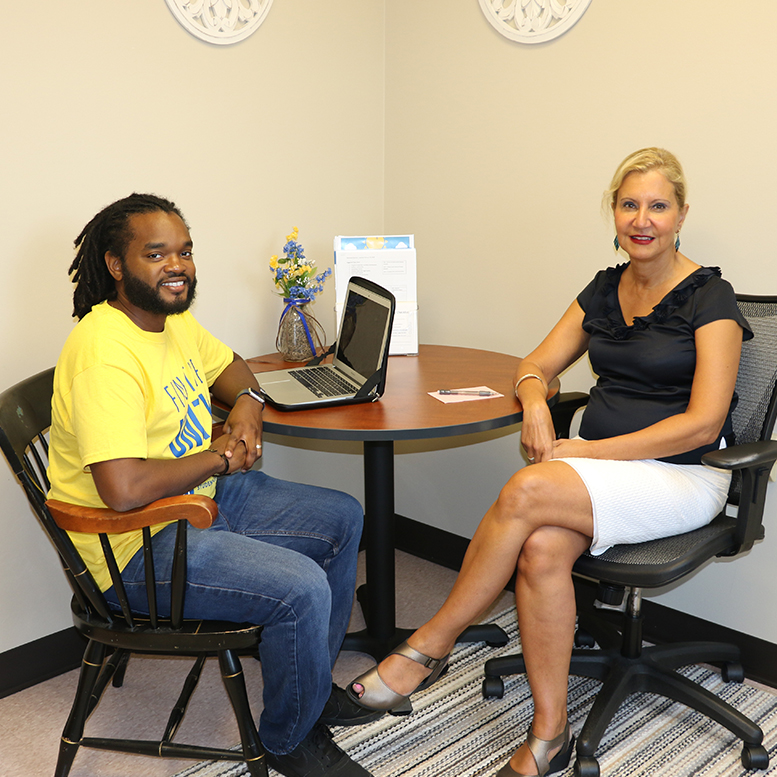 Department chair Bahira Trask talks with doctoral student
