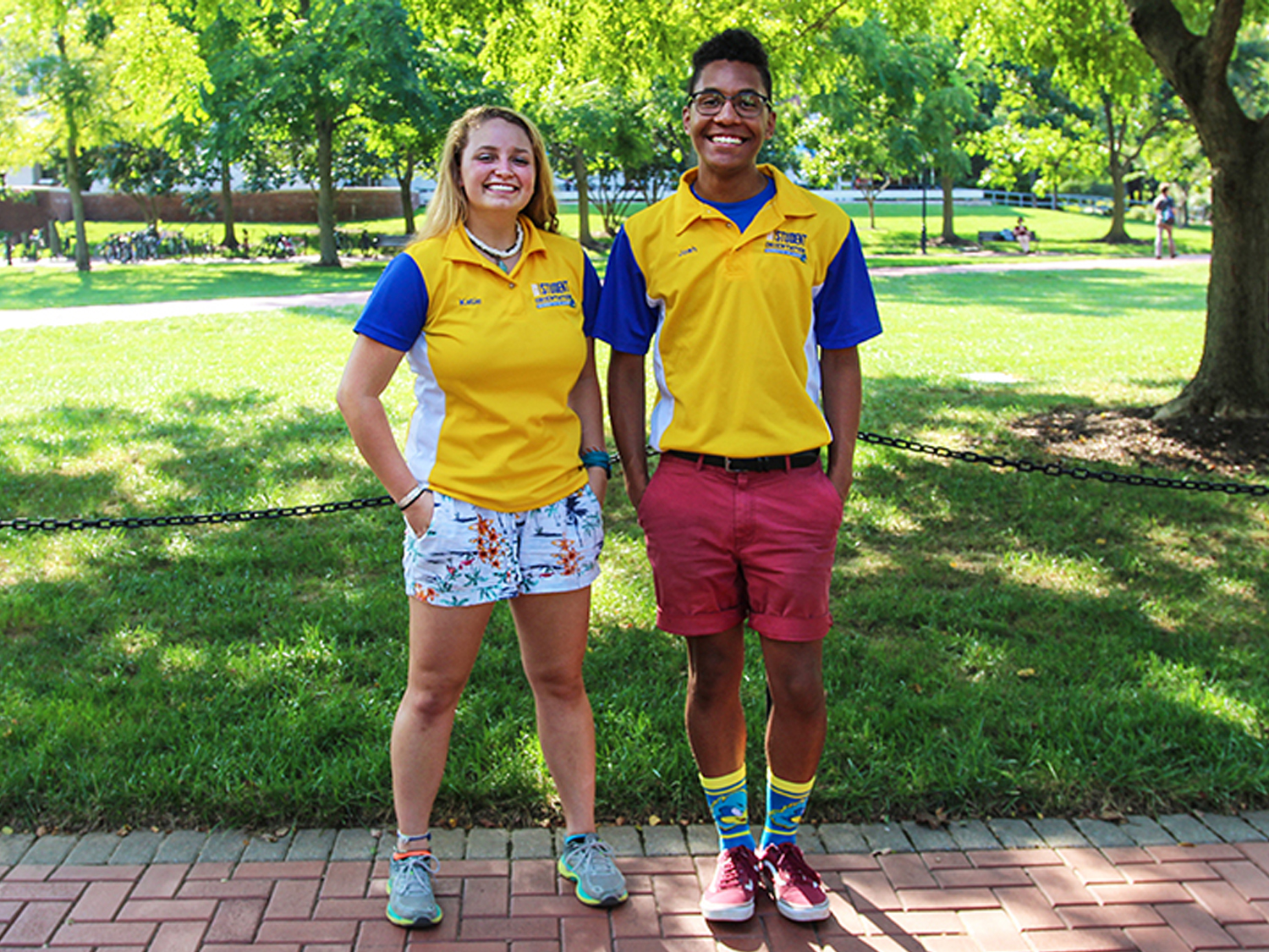 Two CEHD student ambassadors pose on the Unversity green.