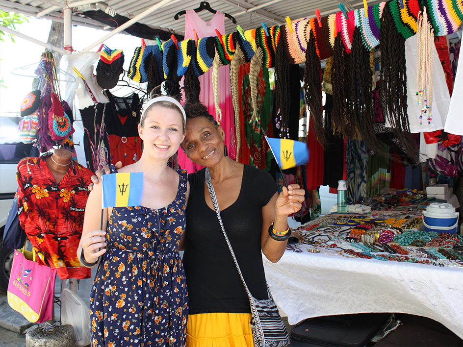 UD student poses with Barbadian flag