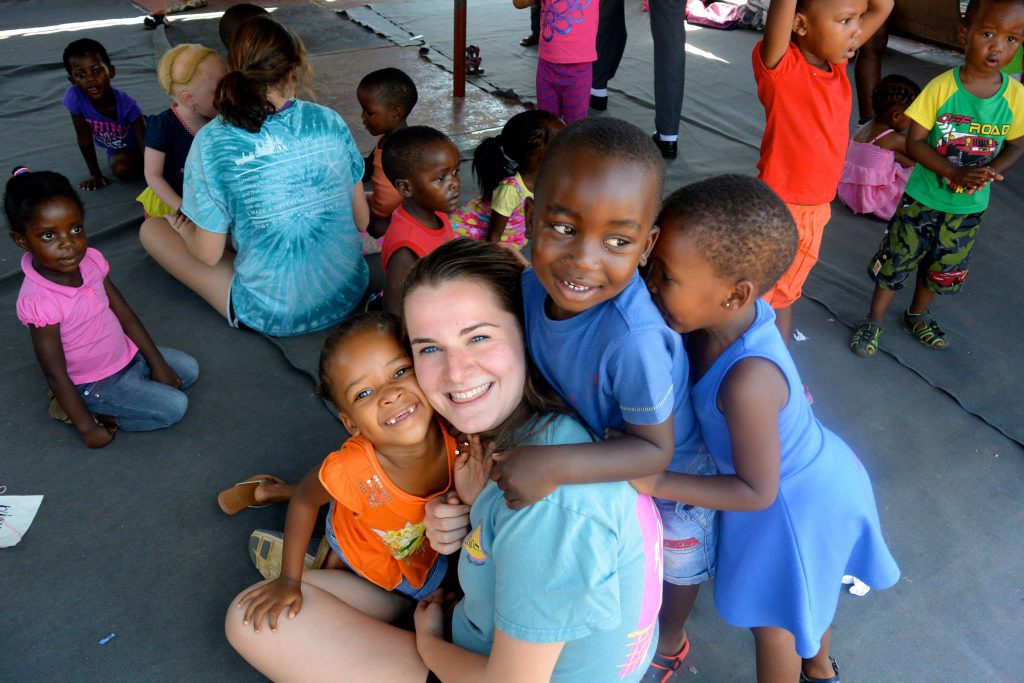 Student hugs child in South Africa during study abroad trip