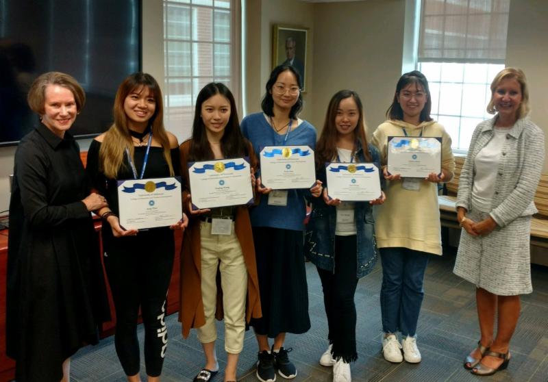 The students receiving their certificates of completion along with Dean Carol Vukelich and Department Chair Bahira Sherif Trask