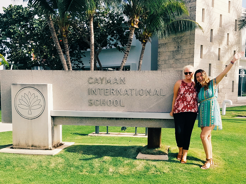 Two UD students posing outside the Cayman International School
