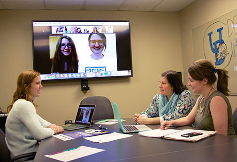 Kathleen McCallops, Cory Gilden and Ginnie Sawyer Morris, doctoral students in Human Development and Family Sciences, connect virtually with colleagues in Greece and Germany to develop a conference that fosters collaborative research