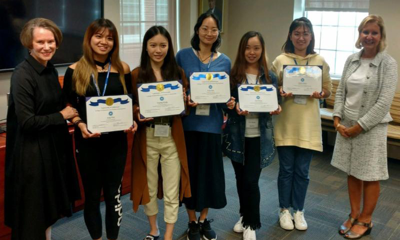 The students receiving their certificates of completion along with Dean Carol Vukelich and Department Chair Bahira Sherif Trask